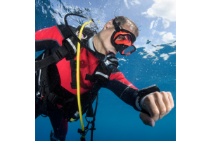 Scuba diver underwater checking his dive computer